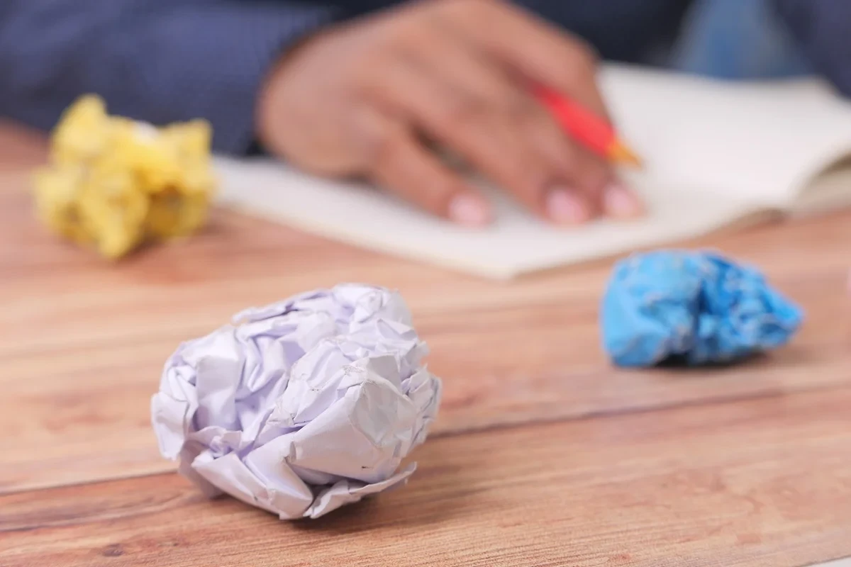 crumpled resume drafts on a table