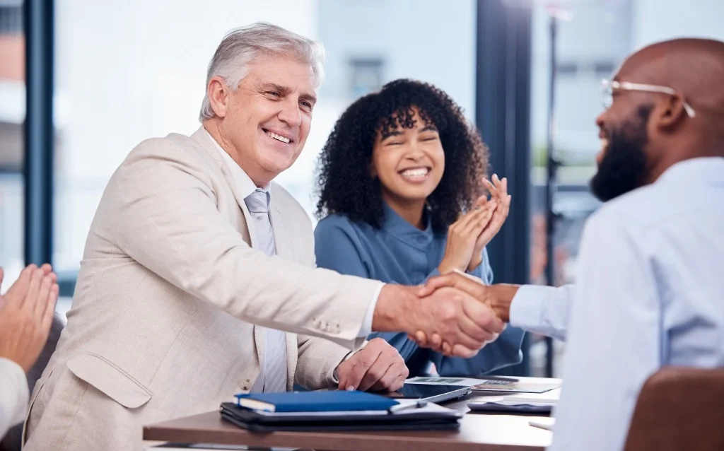 employer shakes hand with interviewee a sign of success