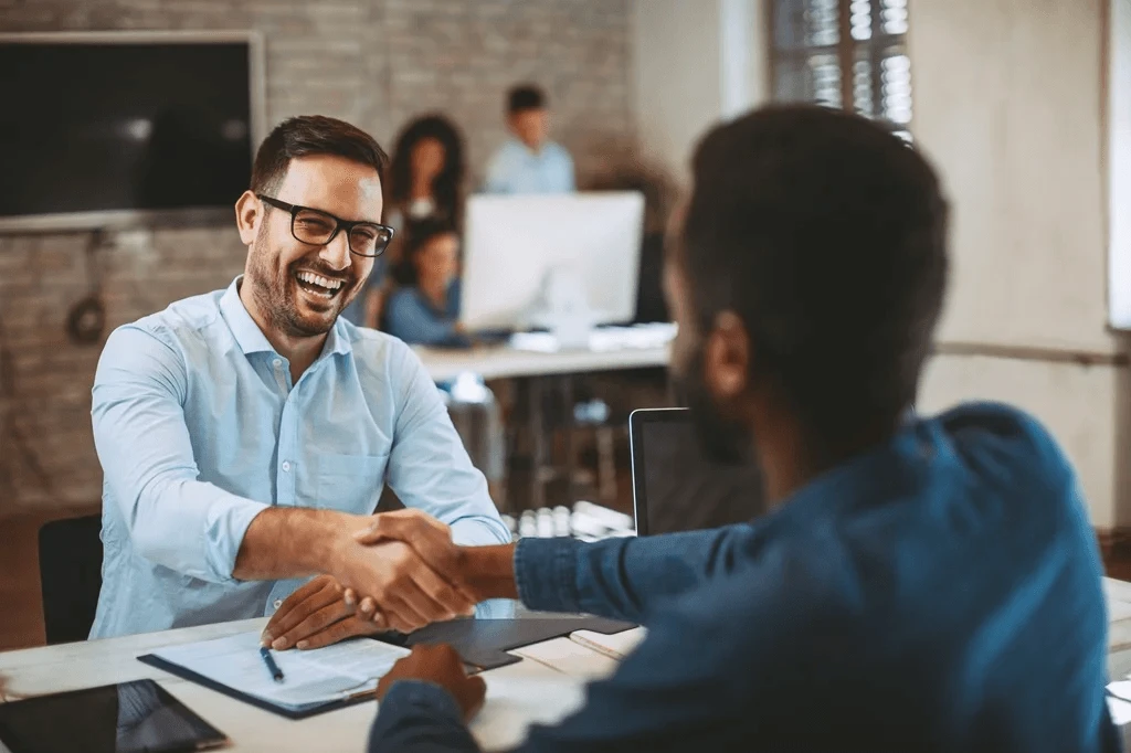 newly hired IT professional shaking hands with the recruiter