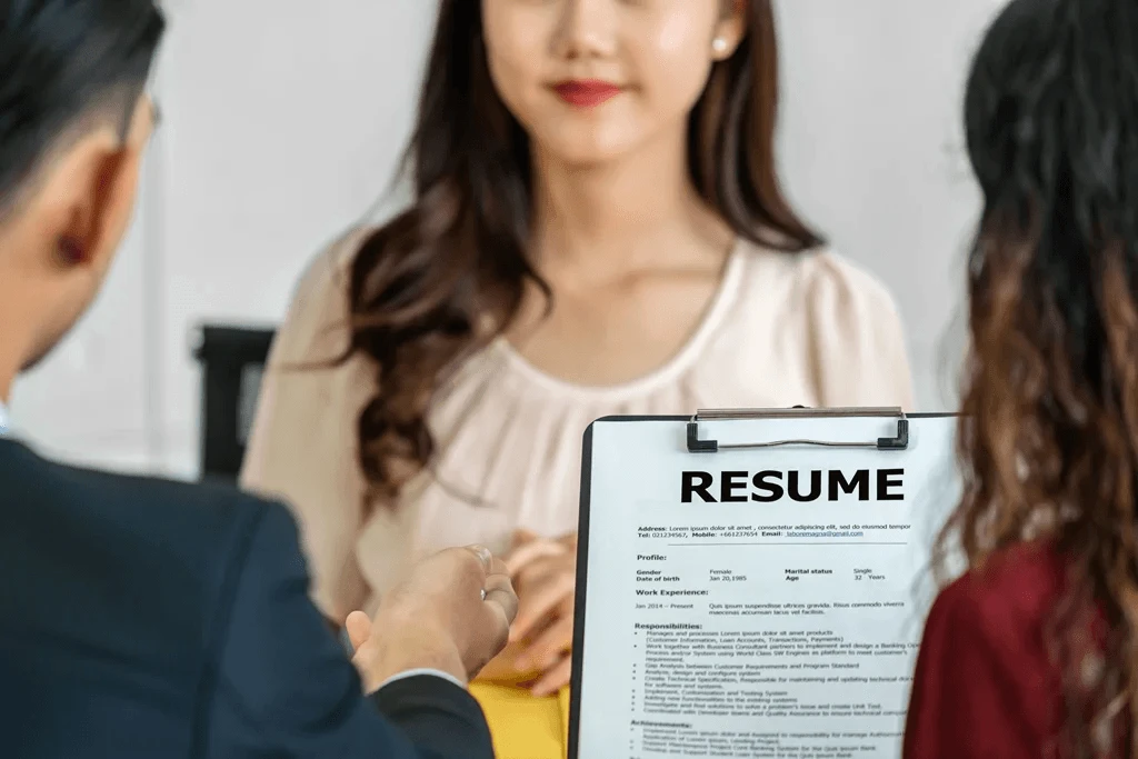 hiring managers reviewing a resume with clear bullet points