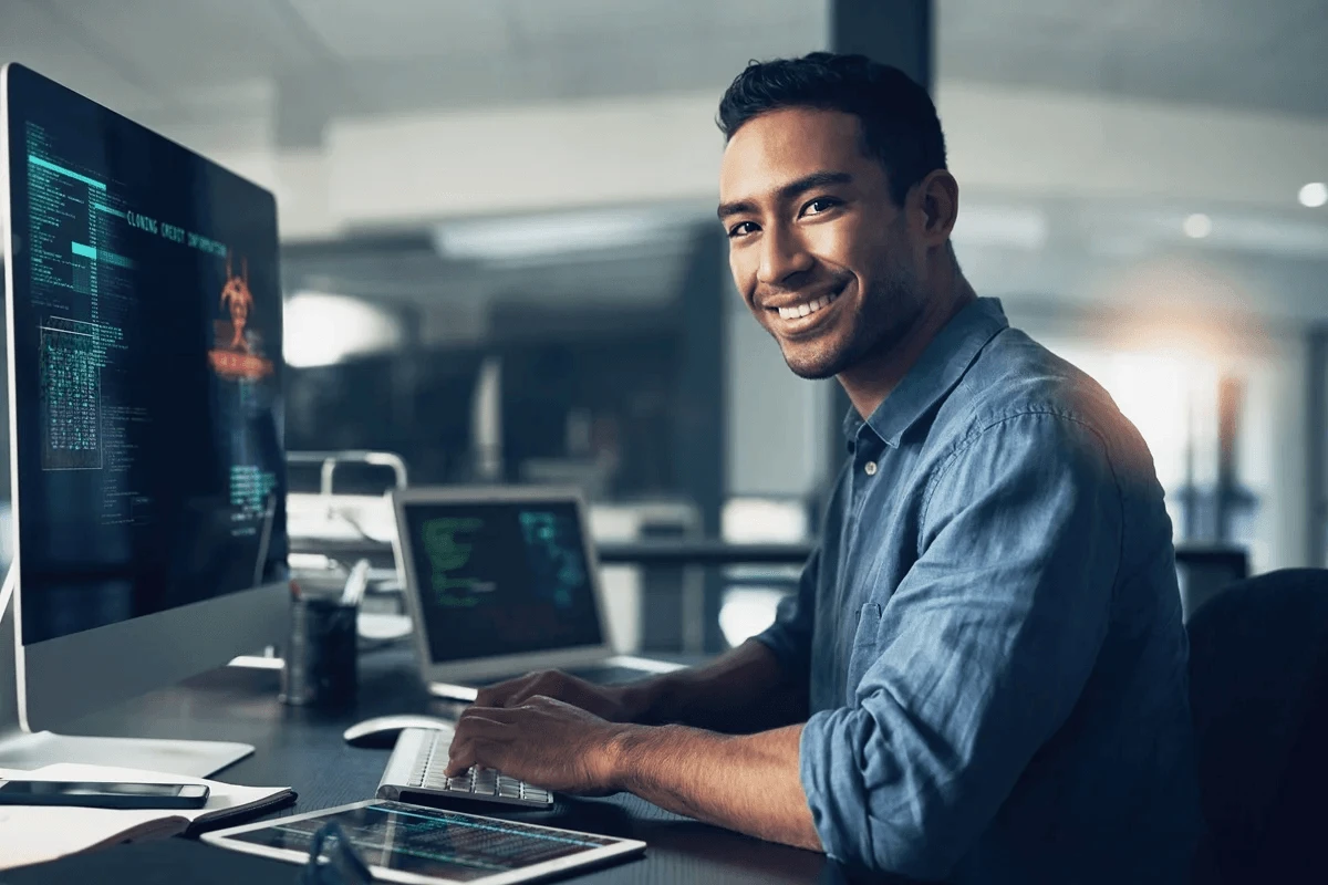 software engineer managing codes using a computer and a personal laptop