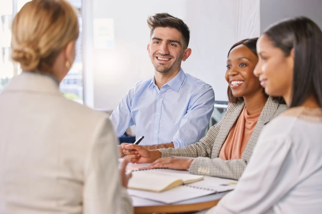 A job seeker confidently asking the hiring manager questions to ask hiring manager during an interview with a diverse panel 1