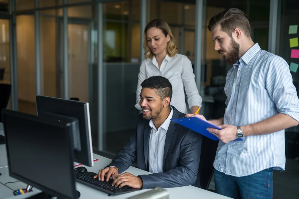 A team of computer systems analysts collaborating in an office